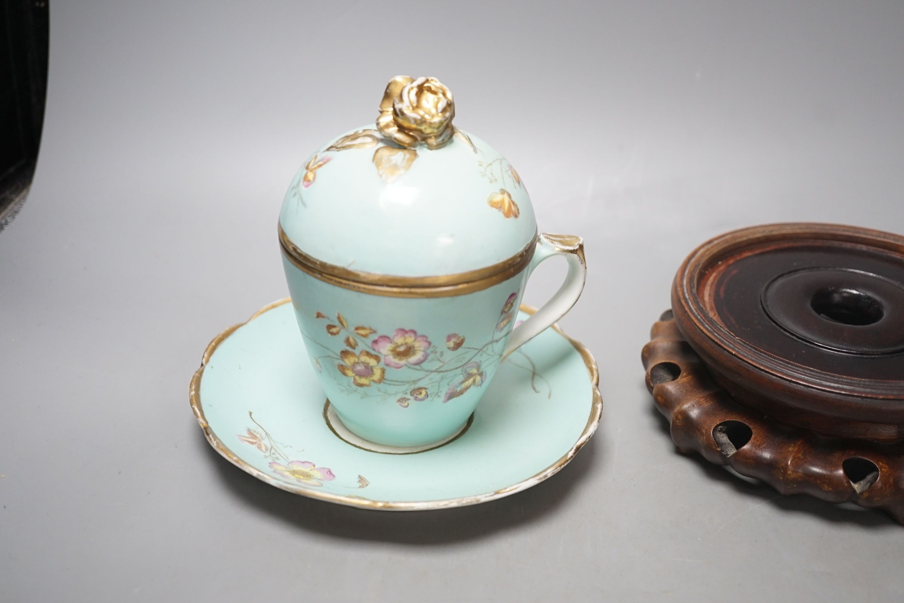 A Continental porcelain jam pot, 15cm tall, and cover with stand, together with 2 Chinese hardwood stands, enamelled plate and another (7)